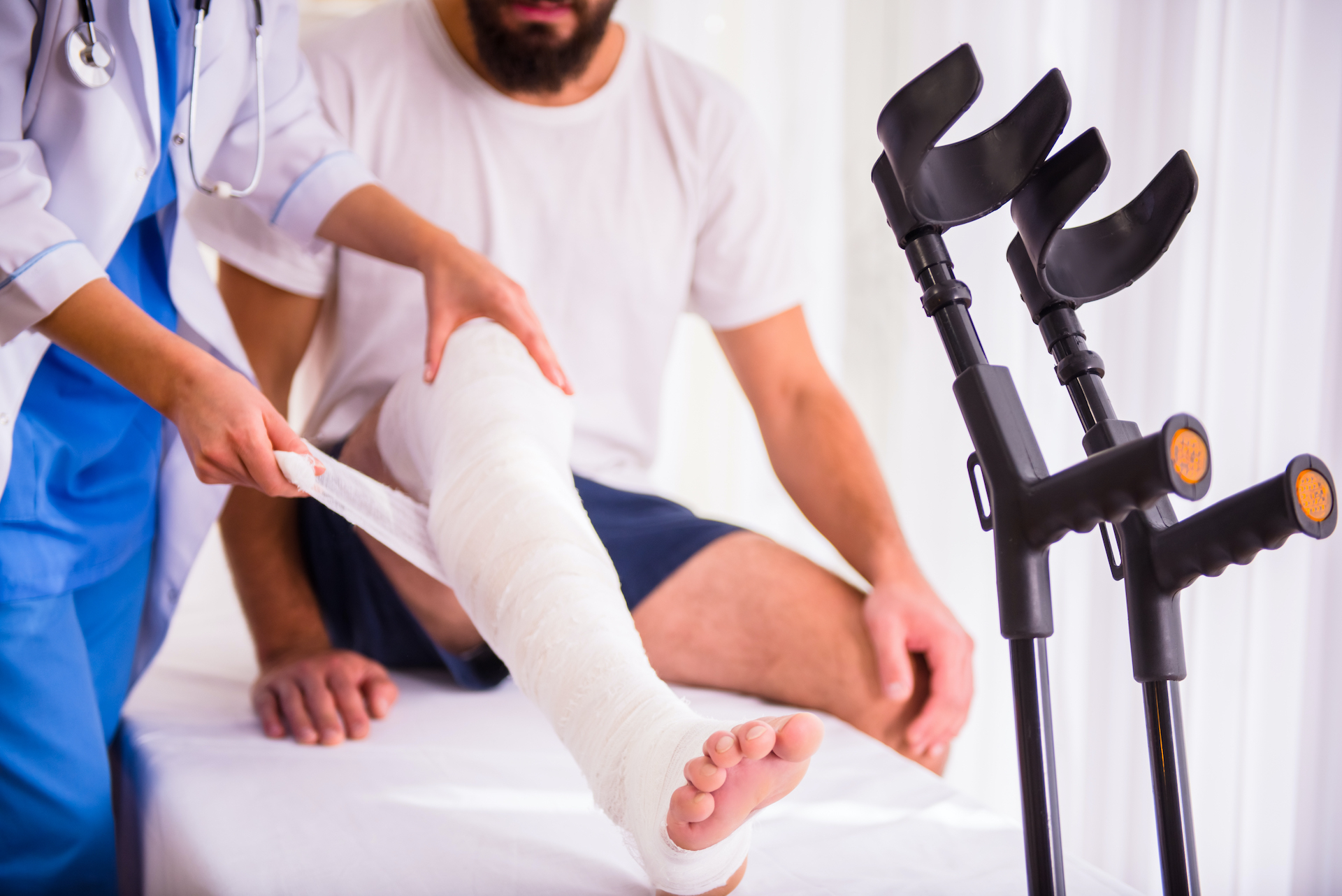 A lady doctor putting a bondage to an Injured leg